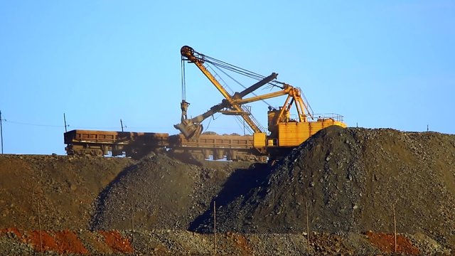 ore loading by the excavator on a rolling stock