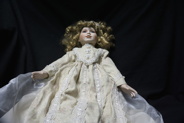 Creepy old, antique doll that looks like it is floating, possessed or haunted.
