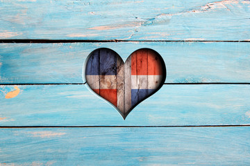 Love Dominican Republic. Heart and flag on a blue wooden board - obrazy, fototapety, plakaty