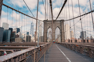 Brooklyn Bridge in New York City with cloudy blue sky at day time.