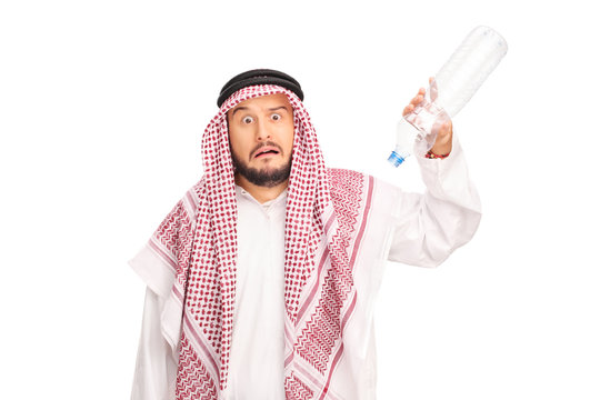 Frightened Arab holding an empty plastic bottle