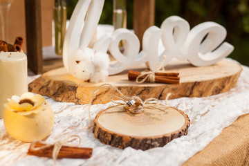 Fototapeta na wymiar Wedding rings on wooden stump