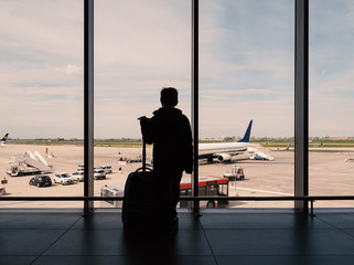Kid looking at airplanes in the airport. © pio3