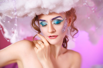 beauty portrait of a woman with a hairstyle cloud over his head and bright makeup