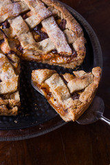 Apple/pear pie in a baking pan, with ingredients.