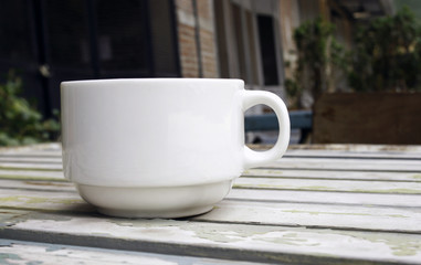 Coffee cup on wood table with blur background