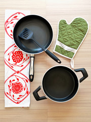 Red pot, pan and green glove (top view)