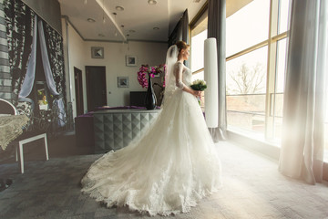 Bride with bouquet in luxury interior