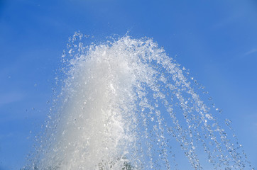 Strong fountain on blue sky background