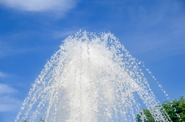 Strong fountain on blue sky background