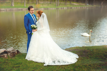 Bride and groom near big lake