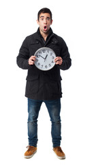 full body young man scared holding a clock