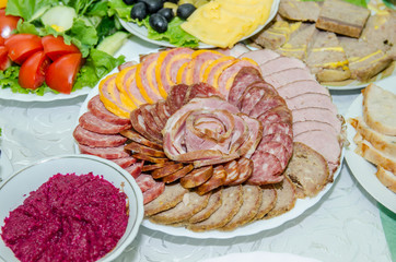 laid table with many dishes on white plates