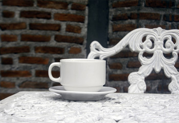 cup of coffee on vintage wrought iron garden table