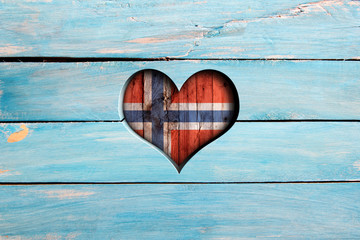 Love Norway. Heart and flag on a blue wooden board