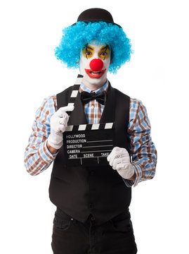 portrait of a funny clown holding a clapper