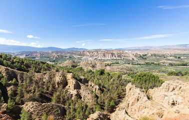 Fototapeta na wymiar Overlook over rugged eroded valley near Guadix Spain