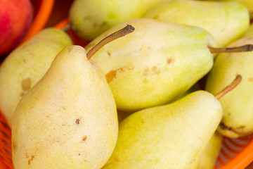 Naklejka na ściany i meble Delicious yellow pears on the counter