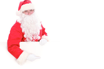 Kind Santa Claus pointing in white blank sign, isolated on white background