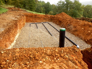 Bottom layer of pipework laid on gravel in the construction of a sand and gravel drainage system