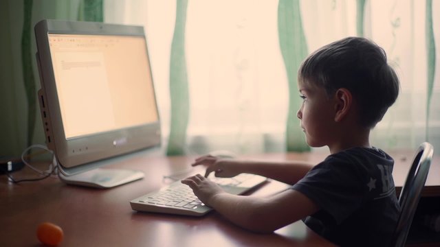 little boy using computer, early education