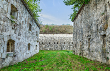 The massive bastions with gun ports and a passage between the inner and outer walls.