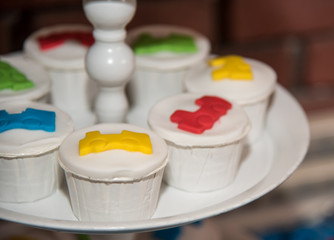 White cupcakes decorated with colored sweets