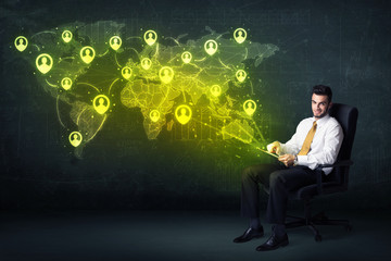 Businessman in office with tablet and social network world map