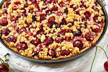 Tasty homemade pie with cherries on table close up