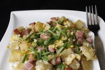 scrambled eggs served with bits of salami