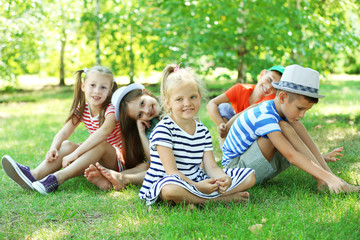 Naklejka na ściany i meble Happy active children on green grass in park