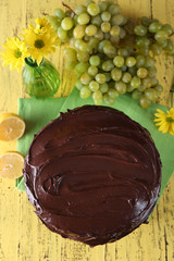 composition of sweet chocolate dessert and fruits on yellow wooden background