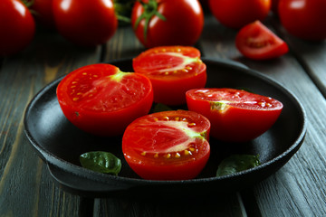 Red tomatoes on wooden background