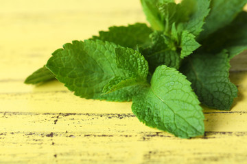 Bunch of mint on yellow wooden background
