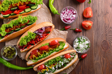 Hot dogs and vegetables on craft paper closeup