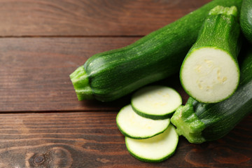 Fresh zucchini on wooden background