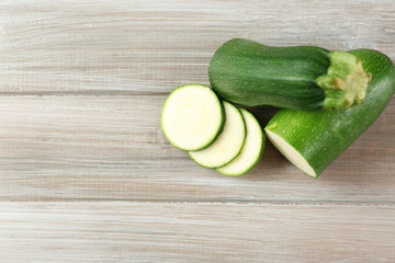 Fresh zucchini on wooden background