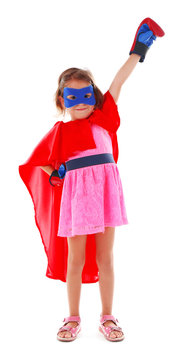 Superhero little girl poses in boxing gloves isolated on white background