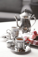 Antique tea-set with Turkish delight on table close-up