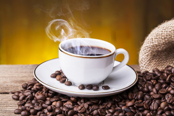 Cup of hot coffee against grunge background