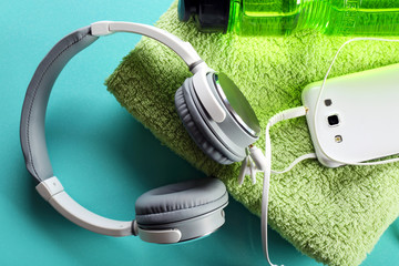Headphones and sport equipment on blue background