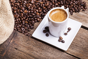 Cup of coffee on aged wooden table