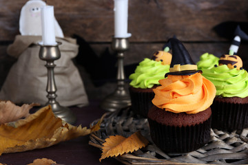 Halloween cupcakes on wicker mat on table