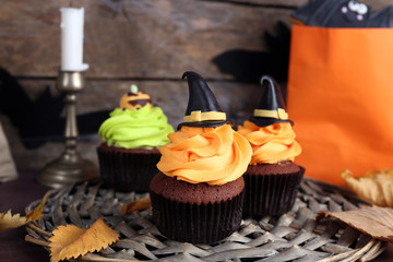 Halloween cupcakes on wicker mat on table