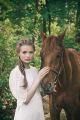 Woman in vintage dress touching to horse face