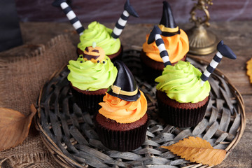 Halloween cupcakes on wicker mat on table