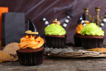 Halloween cupcakes on wicker mat on table