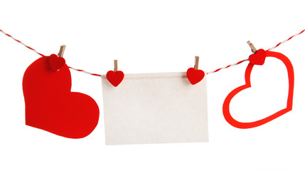 Paper hearts and empty sheet hang on cord isolated on white background