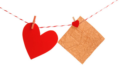 Paper heart and empty sheet hang on cord isolated on white background