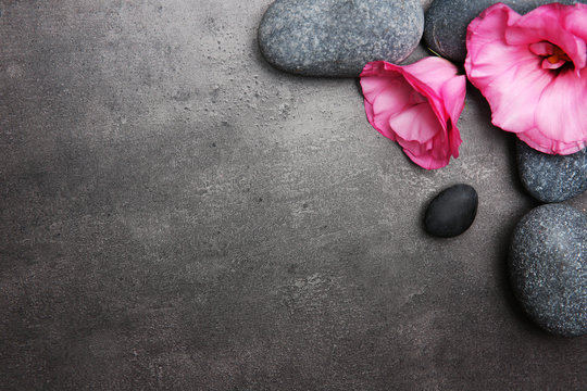 Fototapeta Spa stones and flowers on grey background